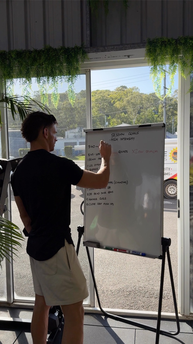 Michael mapping out a client's session plan on a whiteboard